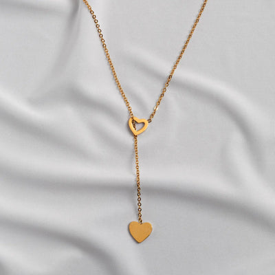 Boucle d'oreille sertie de cœur et collier lariat
